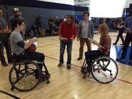 Cample and Daphne playing basketball in a wheelchair