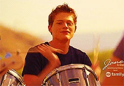 Emmett looking at Bay when he saw her shirt it said Iam with the deaf drummer