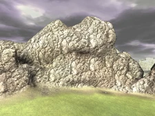 The mountains next to the rock.