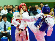 Yau Pui Man (Blue) kicks to Chan Suk Ching's Head (Red)