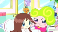 Psychetchi trimming a Tamagotchi's hair