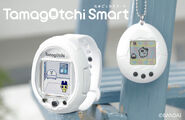 A white P1 next to a 25th Anniversary Tamagotchi Smart.