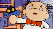 Professor Banzo holding a damaged UFO in Tamagotchi Honto no Hanashi