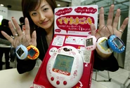 GettyImages-71190057.jpg (476 KB) Lotteria Tamagotchi at press conference with cardboard stand