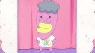 Guidetchi wearing a T-shirt that says "Time Love", from episode 10 of Tamagotchi!