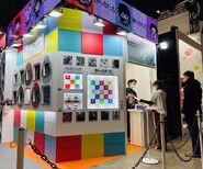 Jump Festa 2022 booth featuring the Jujutsutchi and the Demon Slayer Tamagotchi.