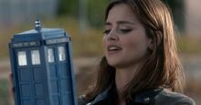 Clara holds the TARDIS