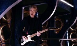 Doctor playing electric guitar in the TARDIS