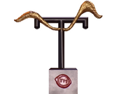 Golden eyebrow trophy (large golden arched eyebrows sprouting from a black capital letter "T" atop a block of wood emblazoned with a Taskmaster red wax seal) from Taskmaster's New Year Treat