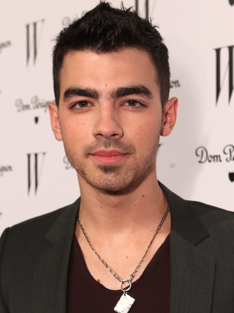 Clad in a cowboy hat, spurs and fringe, singer Joe Jonas taps into