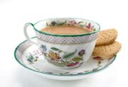 Cup and saucer of tea with biscuits