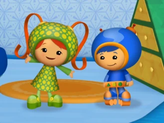 Green with yellow dots dress from Carnival, the same pattern as Geo's stuffed frog toy.