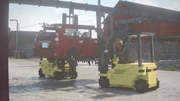 Two Forklifts lifting a mod car