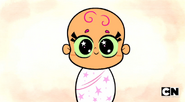 As a baby wrapped in white cloth with pink star patterns