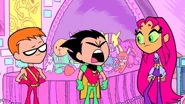 A Bane doll lies with Starfire's Stuffed Animals atop her bed.