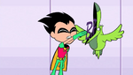 Robin shoves the "BRA" back into Beast Boy's mouth.