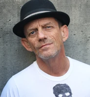 Ezra Buzzington as Travers