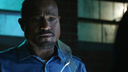 Seth-Gilliam-Deaton-examining-blue-glass-shard-Teen-Wolf-Season-6-Episode-2-Superposition