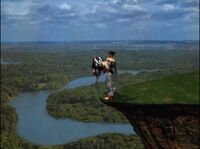 A defeated Heihachi being dropped off a cliff in Kazuya Mishima's Tekken 1 ending.