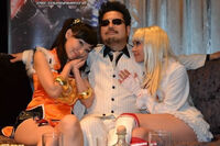 Katsuhiro Harada with two women cosplaying as Xiaoyu and Lili.