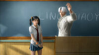 Lee Chaolan introducing Xiaoyu to an empty classroom.