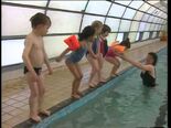 The children swimming with Stephanie at the pool.