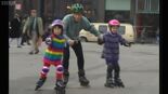 Children and dad rollerblading.