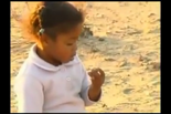 The children on a beach looking for garnets.