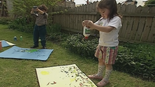 The children squeezy painting in the garden.