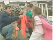 Andy Brown and some children are ready for looking for a dolphin.