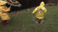 Joseph splashing into a small puddle in the garden