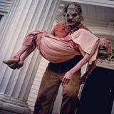 Leatherface carrying his grandmother's corpse.