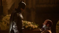 Batman attempting to save  from death.