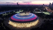 Luzhniki Stadium in sunset, with scenery of Moscow in the background.