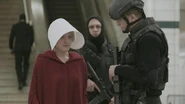 Next to Offred, two heavily armored Guardians in tactical gear, one of them wearing a lightweight FAST helmet.