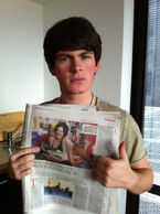 Brad holding Newspaper