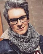 Posted on Brad Kavanagh's Websta/Instagram a day ago: "Proof of life except I’m quite happy today. Me mam got me this nice small snood and it’s making the cold a lot nicer to deal with... #grayhair #prematuregray #noImNot58 #denimjacket #menshaircolor".