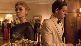 Nicole standing next to Joe Blake in a promotional image.