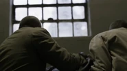 Joe gets captured by the Gestapo officers and was brought to John Smith's office.