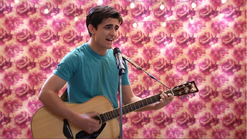 Alfie performs a song in the rose room.