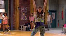 Riley (background, hidden) watches Phoebe dance.