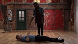 Eldon's hand is shaken by Henry as he lies on the floor.
