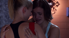 Riley cries in Emily's arms.