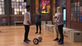 After ordering Kingston off his hoverboard, Michelle (side to camera) asks Kingston to dance for them.