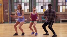 LaTroy teaches Amy and Piper a pop and lock move.