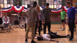 Kingston lies on the floor, his legs hvaing gave out after performing a flip, automatically eliminating him from the dance-a-thon.