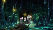 King, Eda, and Amity exploring the caves with a captive Hunter.