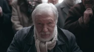 Beth plays an old Russian man on the streets of Moscow