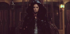 Mary conjuring flames with witch-sticks