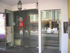The glass door next to Xpose's entrance leading to the stairs to Utterly Art.